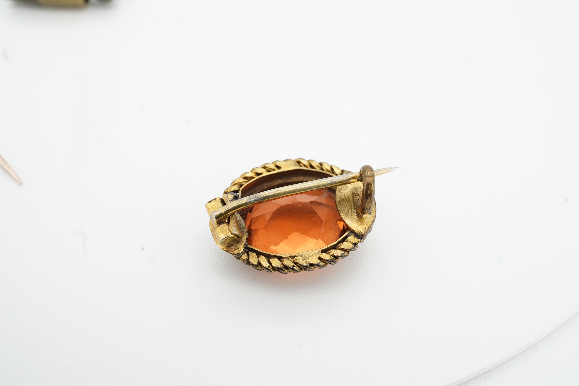 A collection of jewels, comprising: a stick pin, capped with the 'C' cipher with crowned ostrich feather and 'Ich Dien' motto for King Charles when Prince of Wales, in varicoloured gold and enamel, length 6.9cm, gross we